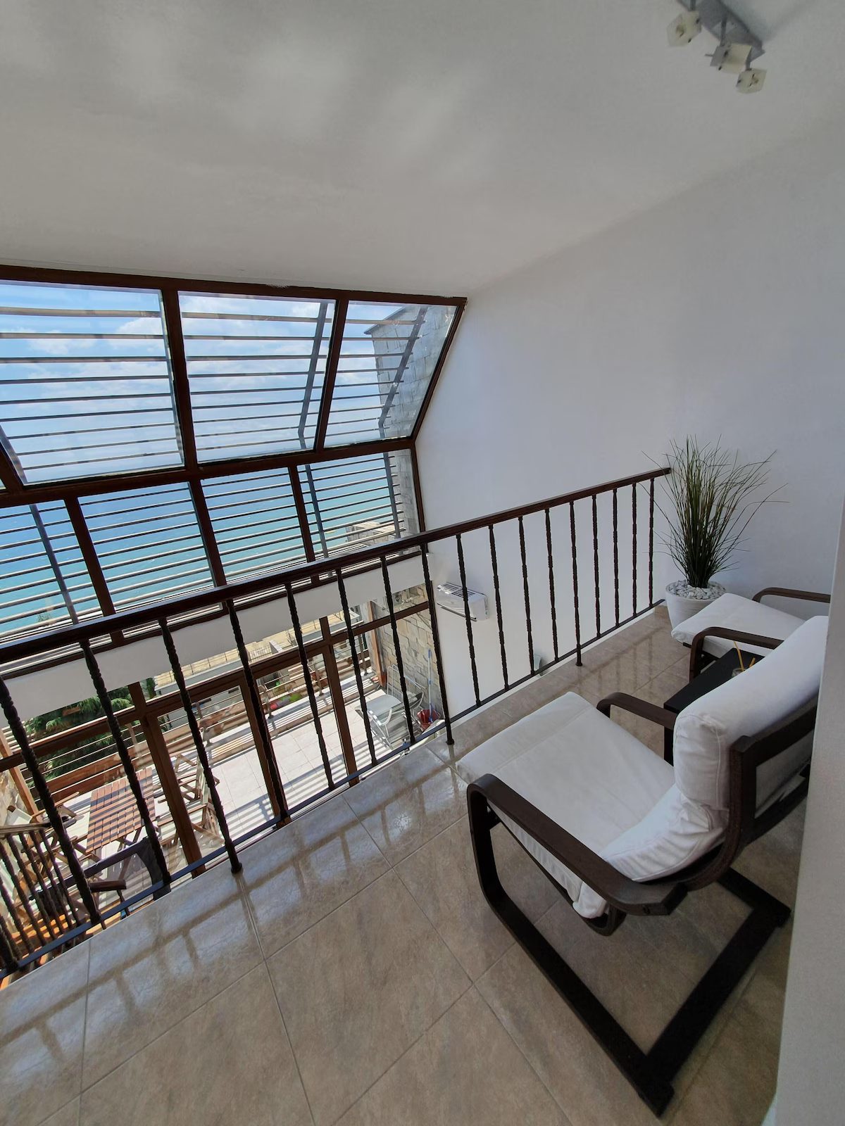 Mezzanine lounge under the glass roof with sea views